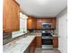 Cozy kitchen featuring granite countertops, tile backsplash, stainless steel appliances and wooden cabinets at 409 Ivy Terrace Dr, Dallas, GA 30157
