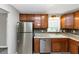 Kitchen featuring granite countertops, tile backsplash, stainless steel appliances and wooden cabinets at 409 Ivy Terrace Dr, Dallas, GA 30157