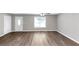 Bright living room with modern wood floors, neutral paint, and lots of light at 409 Ivy Terrace Dr, Dallas, GA 30157