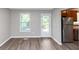 Bright living room with hardwood floors and an adjacent kitchen area at 409 Ivy Terrace Dr, Dallas, GA 30157