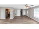 Open-concept living area featuring stylish laminate flooring and a ceiling fan at 409 Ivy Terrace Dr, Dallas, GA 30157