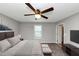 This main bedroom features a ceiling fan, bed and television at 409 Ivy Terrace Dr, Dallas, GA 30157