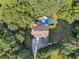 Expansive aerial view of home with backyard pool surrounded by lush greenery and wooded area at 148 Copper Hills Dr, Canton, GA 30114