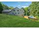 Expansive backyard with above-ground pool, lush grass, and wooded backdrop at 148 Copper Hills Dr, Canton, GA 30114