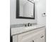 Well-lit bathroom with a granite countertop, white cabinets, and matte black hardware at 148 Copper Hills Dr, Canton, GA 30114