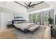 Beautifully staged main bedroom with hardwood floors, large windows, and a tray ceiling at 148 Copper Hills Dr, Canton, GA 30114