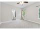 Neutral carpeted bedroom with en suite bathroom, a window, and white painted walls at 148 Copper Hills Dr, Canton, GA 30114