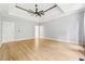 Large bedroom with wood floors, a tray ceiling, and attached bathroom with tile floors at 148 Copper Hills Dr, Canton, GA 30114