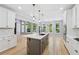 Bright kitchen with stone island, white cabinets, stainless appliances and a view to the backyard at 148 Copper Hills Dr, Canton, GA 30114