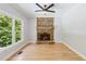 Cozy living room with a stone fireplace and a large picture window with natural light at 148 Copper Hills Dr, Canton, GA 30114