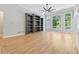 Open-concept living area with built-in bookcases and light hardwood flooring at 148 Copper Hills Dr, Canton, GA 30114