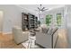 Inviting living room with comfortable seating, built-in bookshelves, and large windows showcasing the view at 148 Copper Hills Dr, Canton, GA 30114