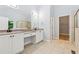 Elegant main bathroom featuring a double vanity, tiled floor, walk-in shower, and access to the walk-in closet at 148 Copper Hills Dr, Canton, GA 30114