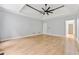 Spacious main bedroom features tray ceilings, fan, and wood floors, offering a luxurious and inviting atmosphere at 148 Copper Hills Dr, Canton, GA 30114