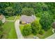 Aerial view of the property and neighborhood, revealing lush trees and a long driveway at 2005 Ashton Pointe Dr, Dacula, GA 30019