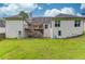 The back of the house has an elevated deck, with steps leading to the grassy yard at 2005 Ashton Pointe Dr, Dacula, GA 30019
