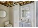 Bathroom features a round mirror, single sink vanity, and toilet at 2005 Ashton Pointe Dr, Dacula, GA 30019