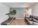 Bonus room with laminate flooring, a treadmill, a sofa, and neutral-toned walls at 2005 Ashton Pointe Dr, Dacula, GA 30019
