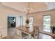 Dining room with tray ceilings, a decorative chandelier, and view to the living area at 2005 Ashton Pointe Dr, Dacula, GA 30019