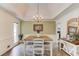 Dining room with tray ceilings, a decorative chandelier, and a wooden table at 2005 Ashton Pointe Dr, Dacula, GA 30019