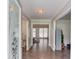 Inviting foyer with hardwood floors and a view into the living area through an elegant door at 2005 Ashton Pointe Dr, Dacula, GA 30019