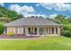 Charming brick home with a covered porch, white columns, and manicured front lawn at 2005 Ashton Pointe Dr, Dacula, GA 30019