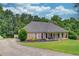 Charming brick home with a large, landscaped yard and inviting front porch, perfect for relaxing at 2005 Ashton Pointe Dr, Dacula, GA 30019