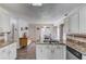 Bright kitchen featuring granite countertops and white cabinets, with views to the breakfast nook and appliances at 2005 Ashton Pointe Dr, Dacula, GA 30019