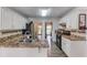 Bright, modern kitchen with granite countertops, stainless steel appliances, and abundant cabinet space at 2005 Ashton Pointe Dr, Dacula, GA 30019