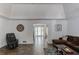 Inviting living room with dark wood floors and ample natural light, featuring a comfortable brown sectional sofa at 2005 Ashton Pointe Dr, Dacula, GA 30019
