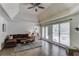 Bright living room featuring hardwood floors, vaulted ceilings, and access to an outdoor deck at 2005 Ashton Pointe Dr, Dacula, GA 30019