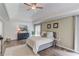 Spacious main bedroom with a tray ceiling, a large bed, and natural light, offering a relaxing retreat at 2005 Ashton Pointe Dr, Dacula, GA 30019