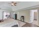 Large main bedroom featuring a tray ceiling, wood floors, and a comfortable bed, with access to a walk-in closet at 2005 Ashton Pointe Dr, Dacula, GA 30019