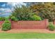 Brick sign for Ashton Pointe community, surrounded by lush greenery, welcomes you home at 2005 Ashton Pointe Dr, Dacula, GA 30019