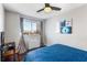 A cozy bedroom featuring hardwood floors, calming wall art, and a comfortable blue quilted bedspread at 215 Piedmont Ne Ave # 1001, Atlanta, GA 30308