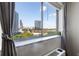 Panoramic cityscape views are framed by large windows and elegant gray curtains at 215 Piedmont Ne Ave # 1001, Atlanta, GA 30308