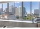 Expansive city view from the window with high-rise buildings against a beautiful blue sky backdrop at 215 Piedmont Ne Ave # 1001, Atlanta, GA 30308