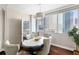 Bright dining room featuring hardwood floors, city views, and a stylish chandelier at 215 Piedmont Ne Ave # 1001, Atlanta, GA 30308