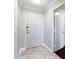 Hallway with tile flooring, white walls, and multiple doorways at 215 Piedmont Ne Ave # 1001, Atlanta, GA 30308