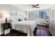 Inviting main bedroom with a large window, hardwood floors, and a ceiling fan at 215 Piedmont Ne Ave # 1001, Atlanta, GA 30308