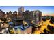 Stunning dusk aerial view of buildings in an urban setting with lights illuminating the city at 215 Piedmont Ne Ave # 2208, Atlanta, GA 30308