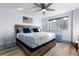 Bedroom with hardwood floors, ceiling fan, city views, and a large window at 215 Piedmont Ne Ave # 2208, Atlanta, GA 30308