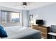 Bedroom with hardwood floors, ceiling fan, city views, and a large window at 215 Piedmont Ne Ave # 2208, Atlanta, GA 30308