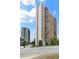 Modern high-rise apartment building with brick and white accents against a blue sky backdrop at 215 Piedmont Ne Ave # 2208, Atlanta, GA 30308