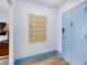 Hallway view featuring modern art on the wall and a light blue door, offering a welcoming entrance at 215 Piedmont Ne Ave # 2208, Atlanta, GA 30308