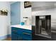 Convenient kitchen area with a coffee maker and blue cabinets with gold pulls at 215 Piedmont Ne Ave # 2208, Atlanta, GA 30308