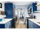 Efficient galley kitchen equipped with stainless steel appliances and modern blue cabinets at 215 Piedmont Ne Ave # 2208, Atlanta, GA 30308