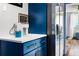 Charming kitchen features navy cabinets with gold hardware, stainless fridge, and white countertops at 215 Piedmont Ne Ave # 2208, Atlanta, GA 30308