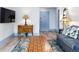 Living room featuring a blue sofa, patterned rug, wood accents and laminate flooring at 215 Piedmont Ne Ave # 2208, Atlanta, GA 30308