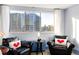 Living room seating area with city views from large windows and matching chairs at 215 Piedmont Ne Ave # 2208, Atlanta, GA 30308